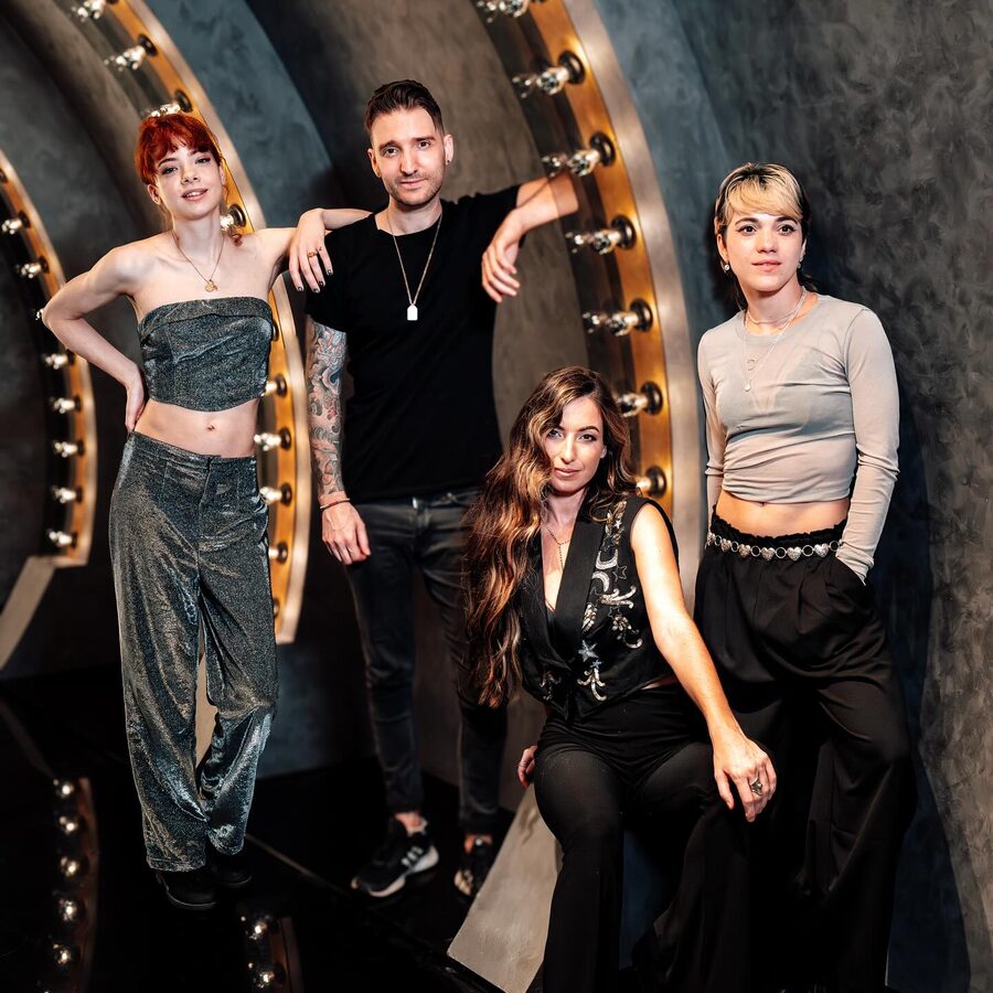 Ark Angels styled group portrait against a gold wall