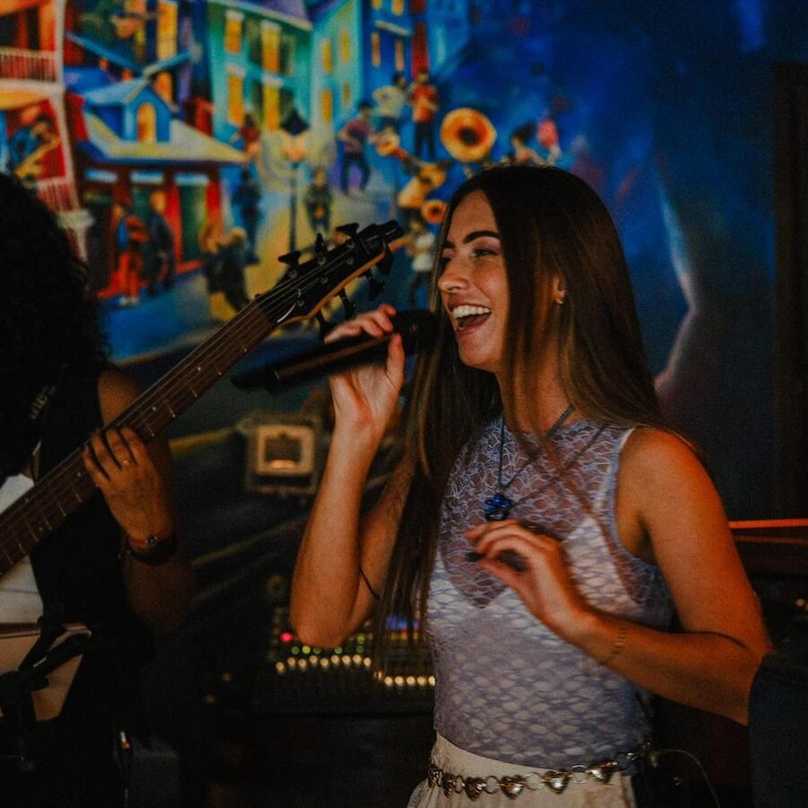 Georgia singing mid-set at a Dubai venue