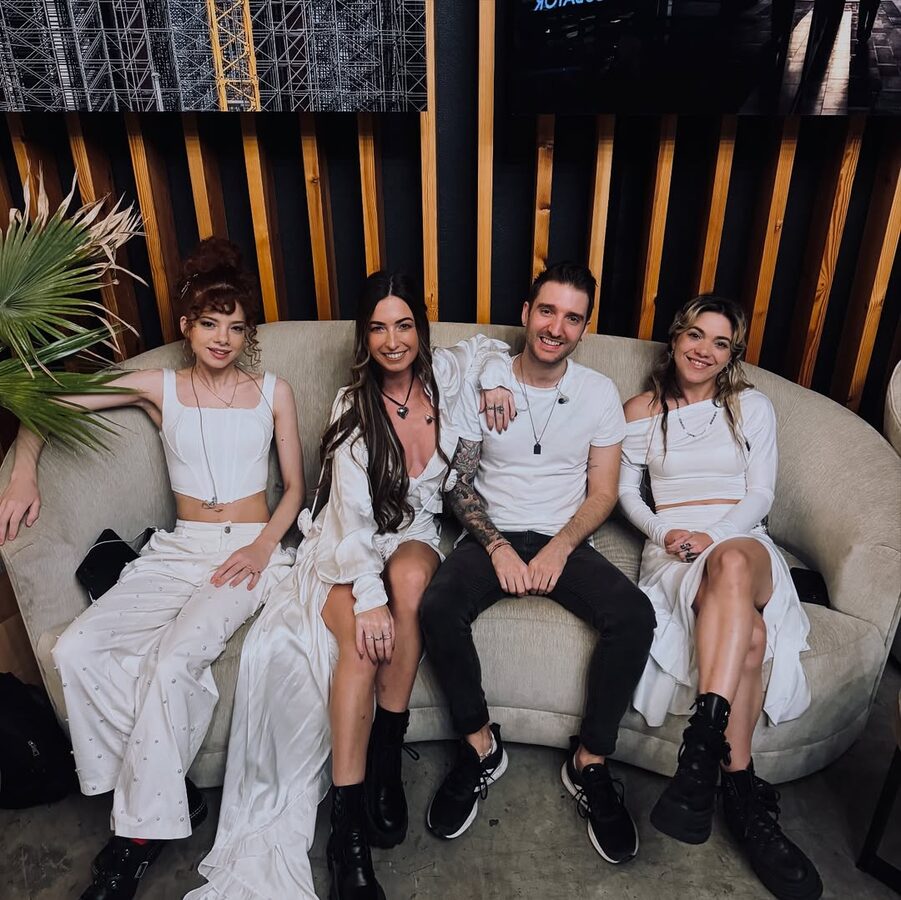 The band relaxing together on a sofa before a show