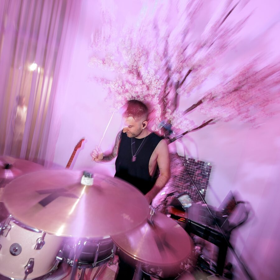 Scott on drums surrounded by cherry blossom