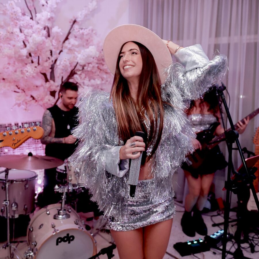 Georgia in a silver tinsel jacket fronting the band