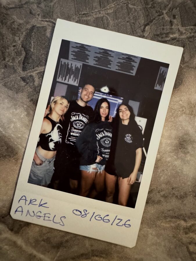 Polaroid of Ark Angels pinned to the wall, June 2026